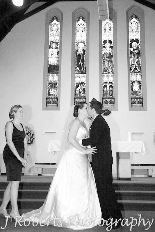 Couples first kissing after marriage ceremony - wedding photography sydney
